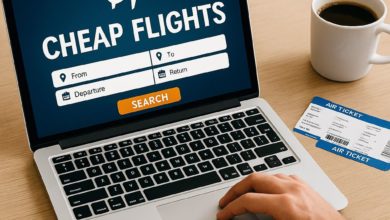Person searching for cheap flights on a laptop with airplane tickets and coffee