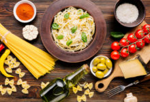 Table filled with traditional Italian dishes like pasta, bruschetta