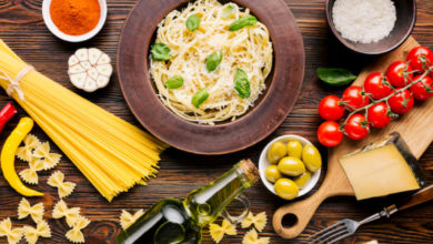 Table filled with traditional Italian dishes like pasta, bruschetta