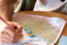 Solo traveler reading a map in a foreign city