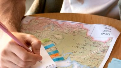 Solo traveler reading a map in a foreign city